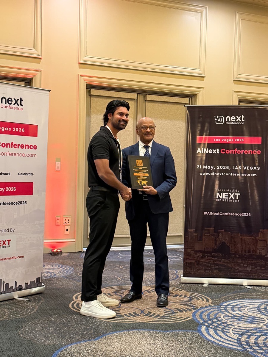 Sameer Khan accepting the AI Powered Transformation Partner award at the AiNext Conference, Las Vegas, May 2026.
